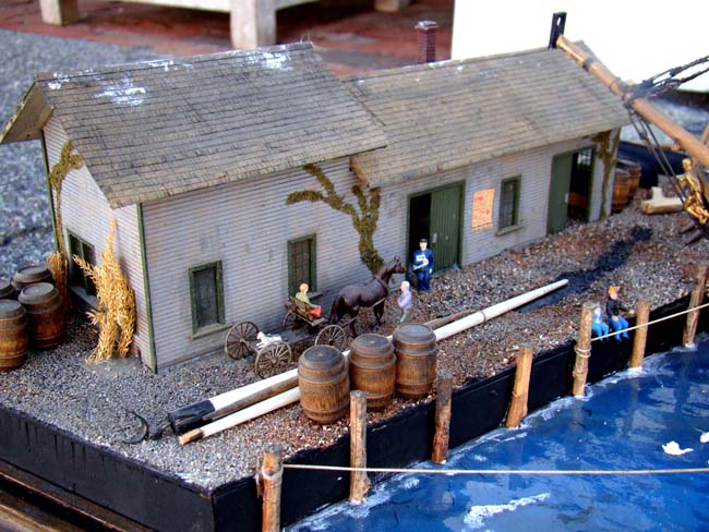 A fabulous and highly detailed scale model diorama circa 1920 of a New England Ship yard circa 1800-1812 making repairs on a 38 Gun American Frigate and a 10 Gun Privateer built circa 1785. — image 9
